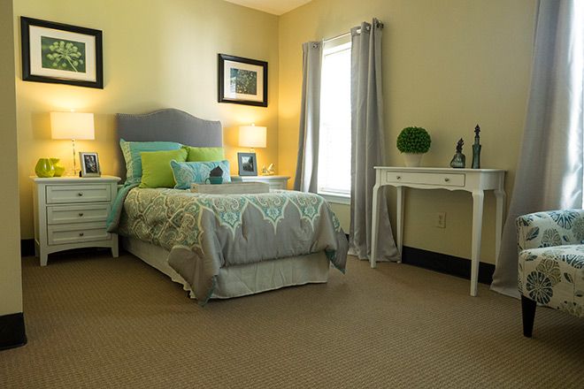 A cozy bedroom with a neatly made single bed, soft lighting, and elegant decor.
