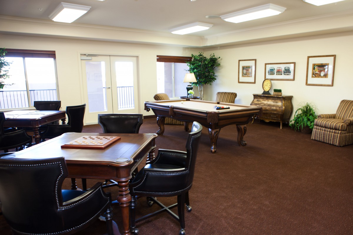 A cozy game room featuring a pool table and seating for board games.
