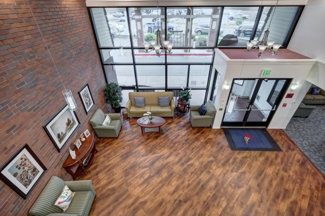 A spacious lobby with comfortable seating and large windows.