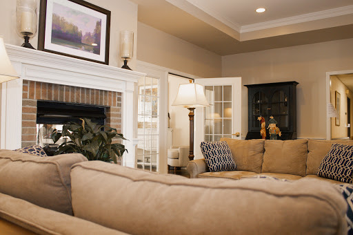A cozy living room featuring a comfortable sofa, stylish lamp, and decorative artwork.