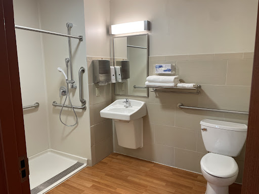 A modern and accessible bathroom featuring a shower, sink, and toilet.