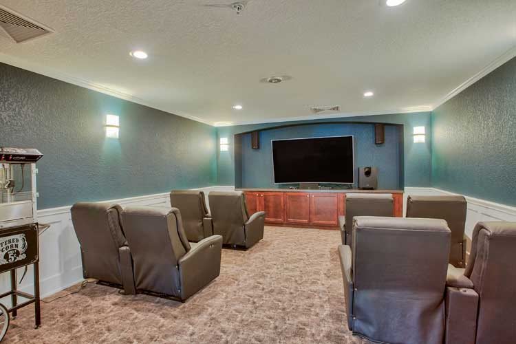 A cozy home theater with comfortable seating and a large screen.
