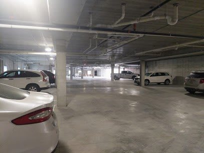 A spacious underground parking garage with parked cars.
