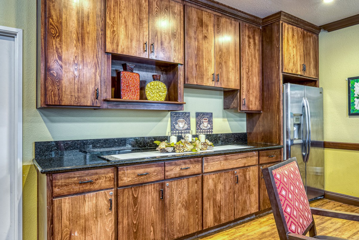 A vintage-style kitchen with wooden cabinets and decorative accents.