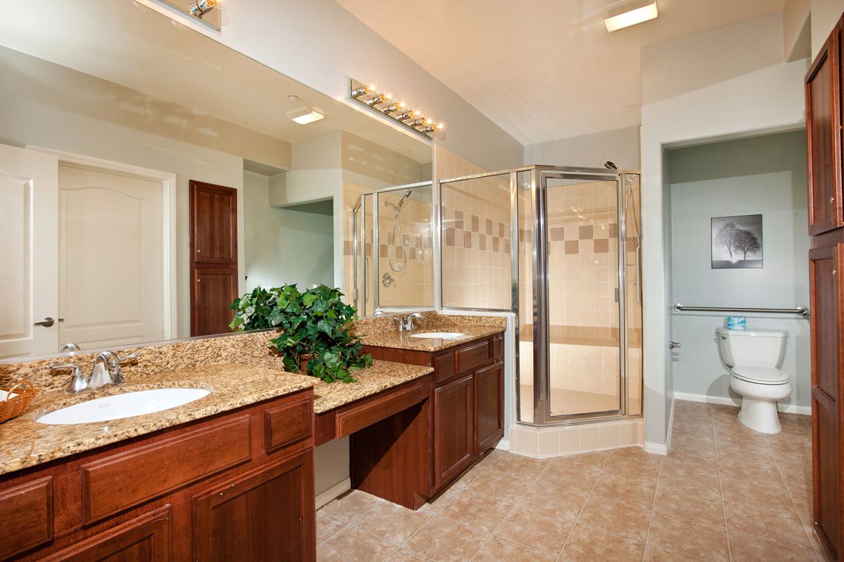 A modern bathroom with a double vanity and spacious shower.