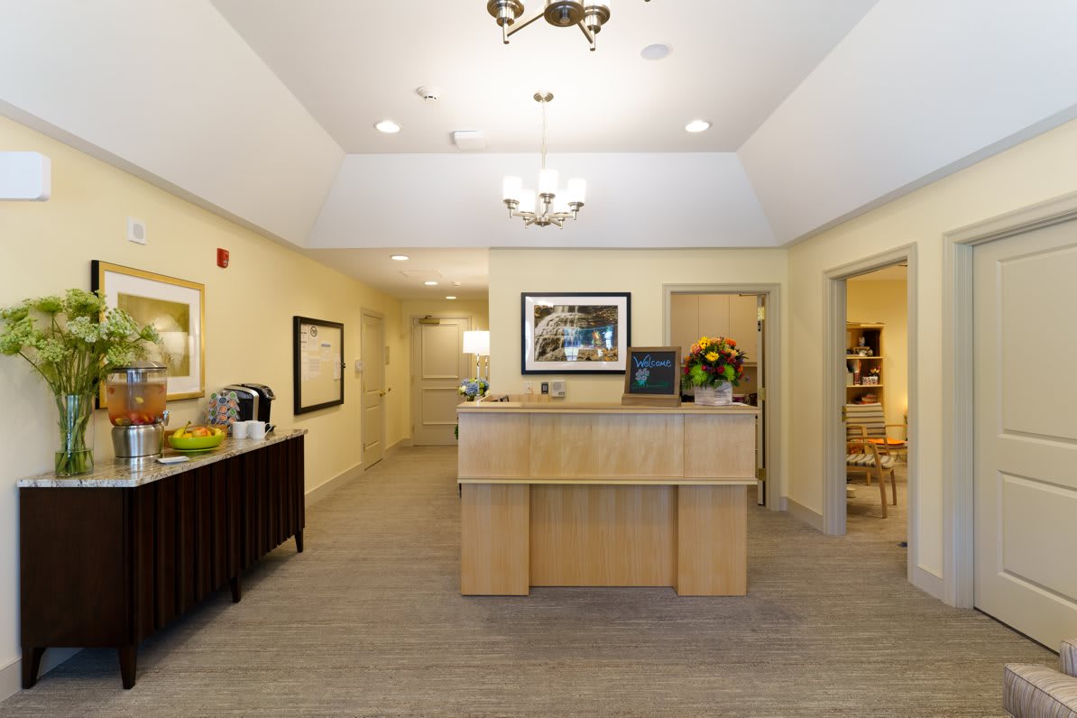A well-lit reception area featuring a front desk and comfortable decor.