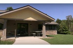A suburban house with a covered porch and a brick exterior.