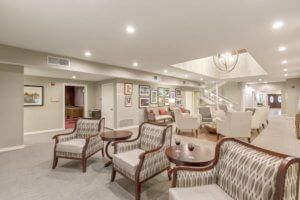 A spacious and elegantly furnished living room with multiple seating areas.