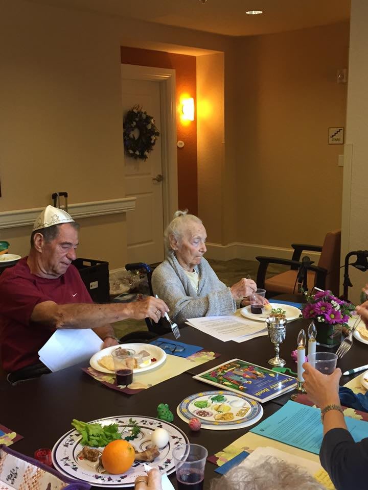 A group of people enjoying a meal together at a dining table, possibly celebrating an occasion.
