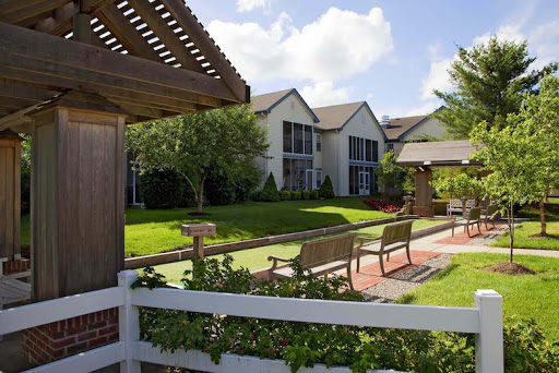 A peaceful residential area featuring well-maintained gardens and inviting benches for relaxation.