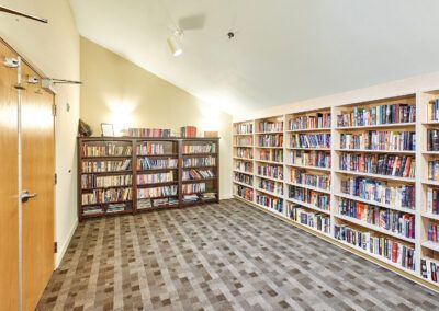 A cozy library room filled with neatly arranged books on shelves.