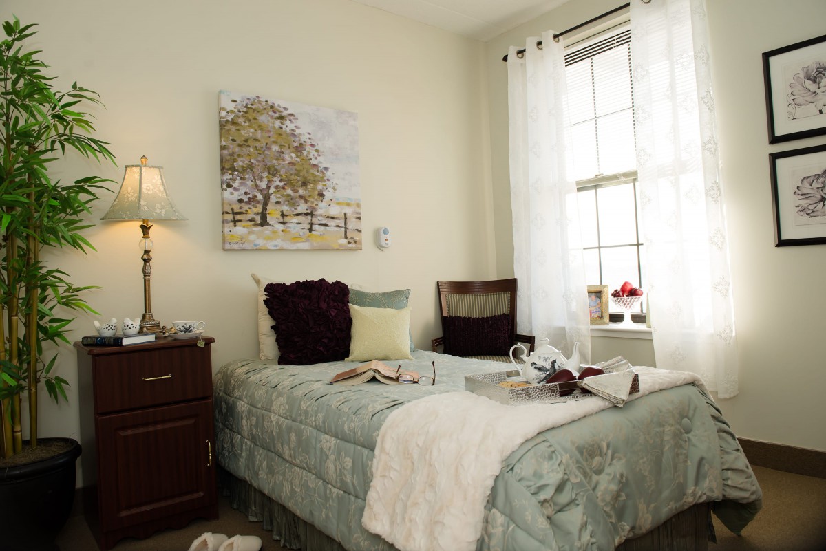 A cozy bedroom with soft lighting and inviting decor.