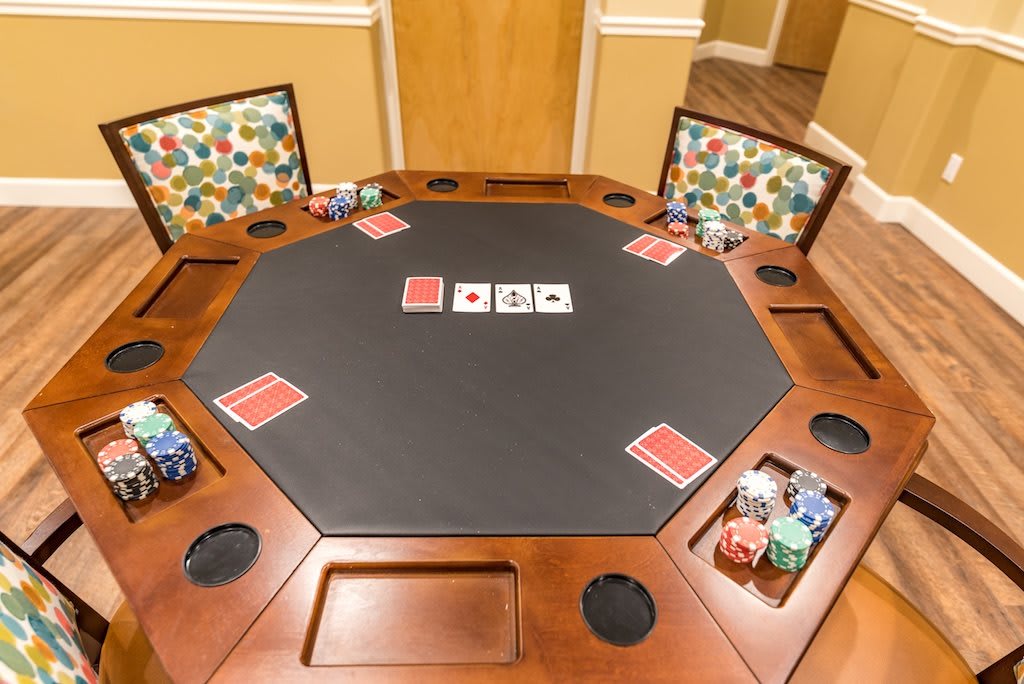 A poker table set up for a game night with cards and chips arranged neatly.