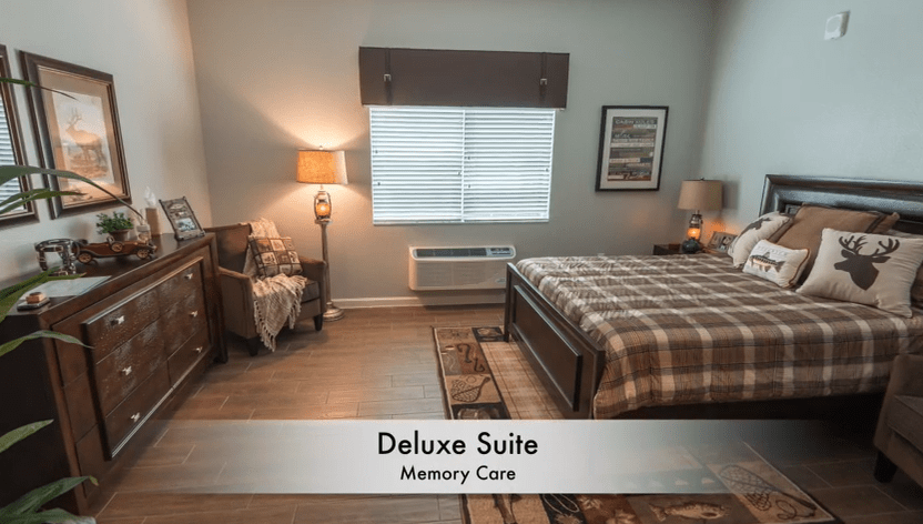 A cozy deluxe suite with tasteful decor and comfortable furnishings, designed for memory care.