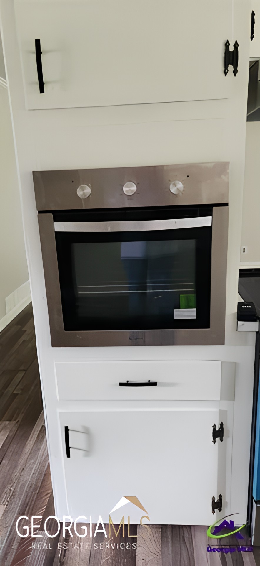 A modern stainless steel built-in oven in a kitchen setting.
