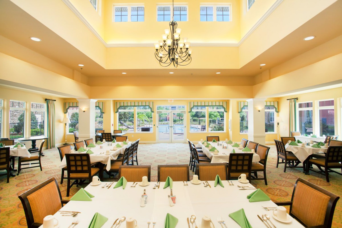 A beautifully arranged dining room with elegant decor and bright lighting.