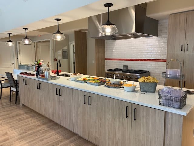 A buffet setup on a kitchen counter with various food items.