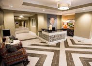 A modern hotel lobby with stylish reception area and geometric flooring.