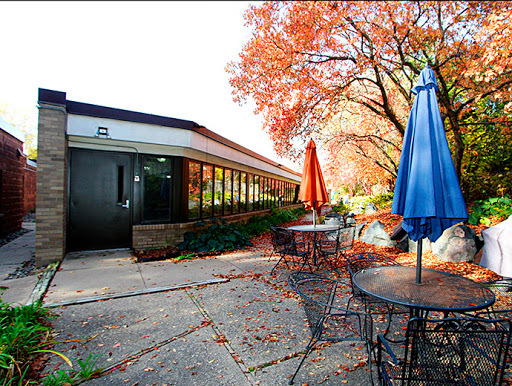 A cozy outdoor caf scene surrounded by vibrant autumn foliage.