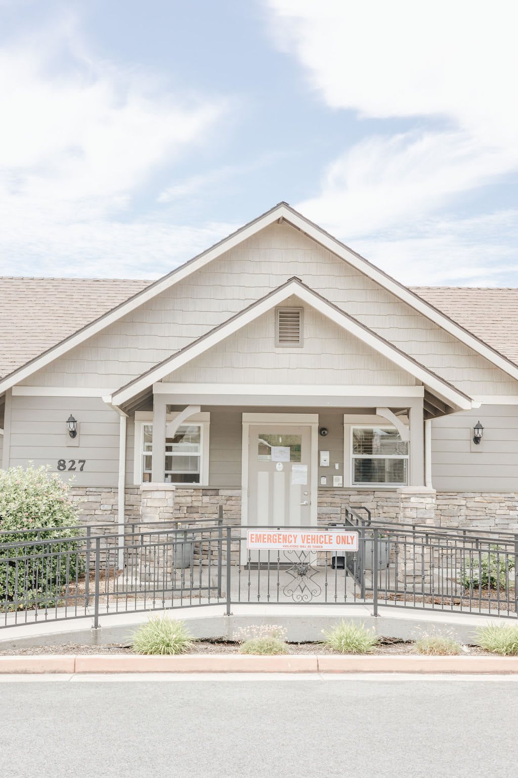 A suburban house with a welcoming front porch and neatly maintained exterior.