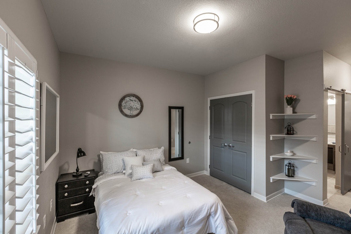 A modern minimalist bedroom with stylish decor and furniture.