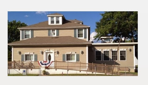 A charming two-story home with a welcoming entrance and decorative accents.
