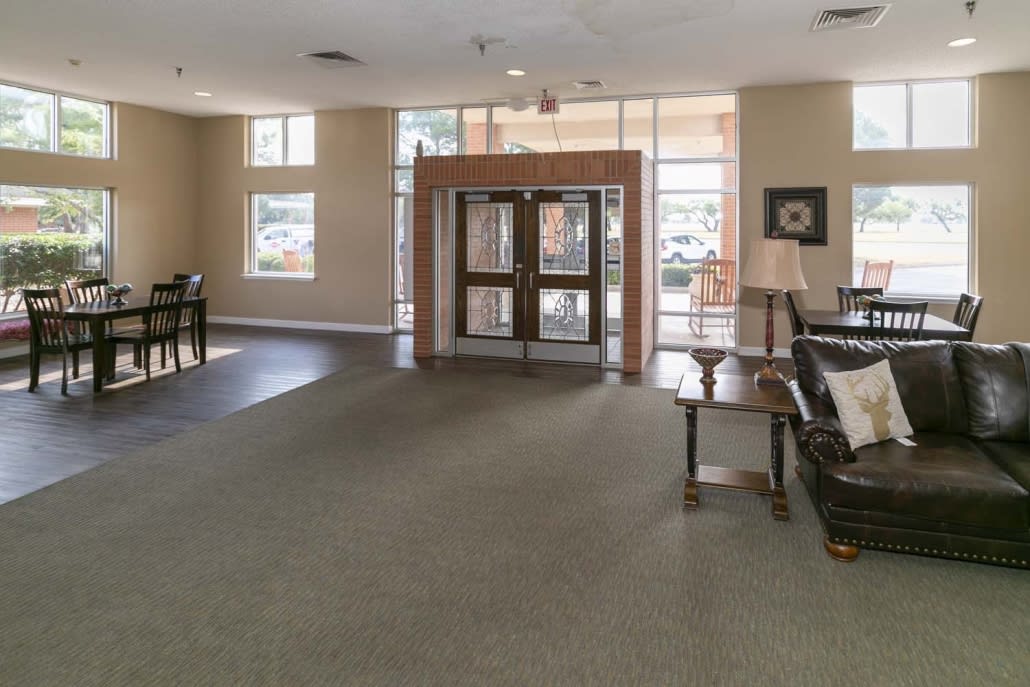 A spacious lobby with glass entrance doors and comfortable seating.