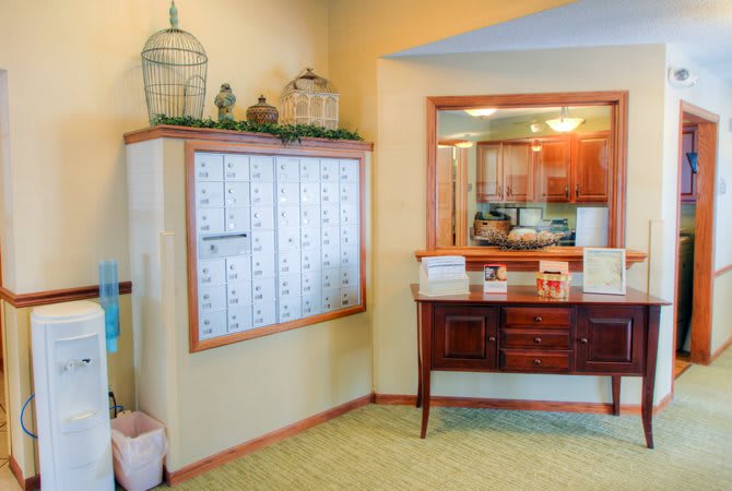 A community mailroom with decorative elements and wooden furniture.