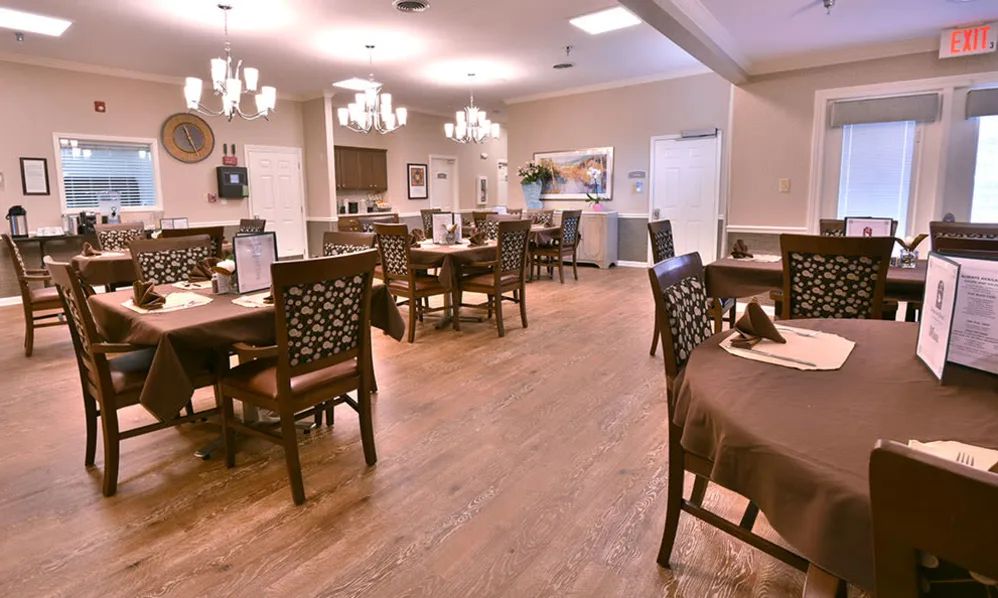 A cozy dining area with wooden floors and elegant lighting.