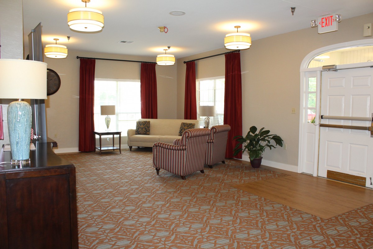 A cozy living room with comfortable seating, elegant curtains, and soft lighting.