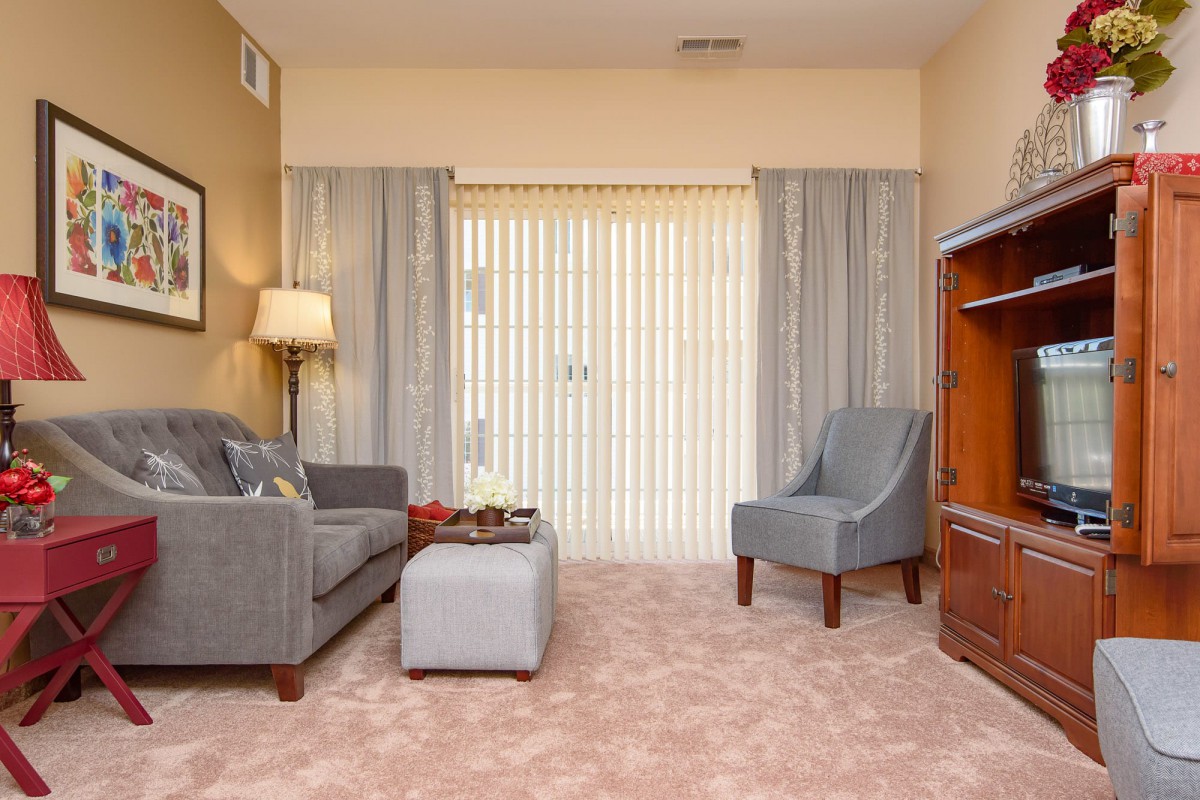 A cozy living room with a sofa, armchair, and coffee table.