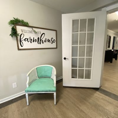 A cozy corner with farmhouse-themed decor and a mint green chair.