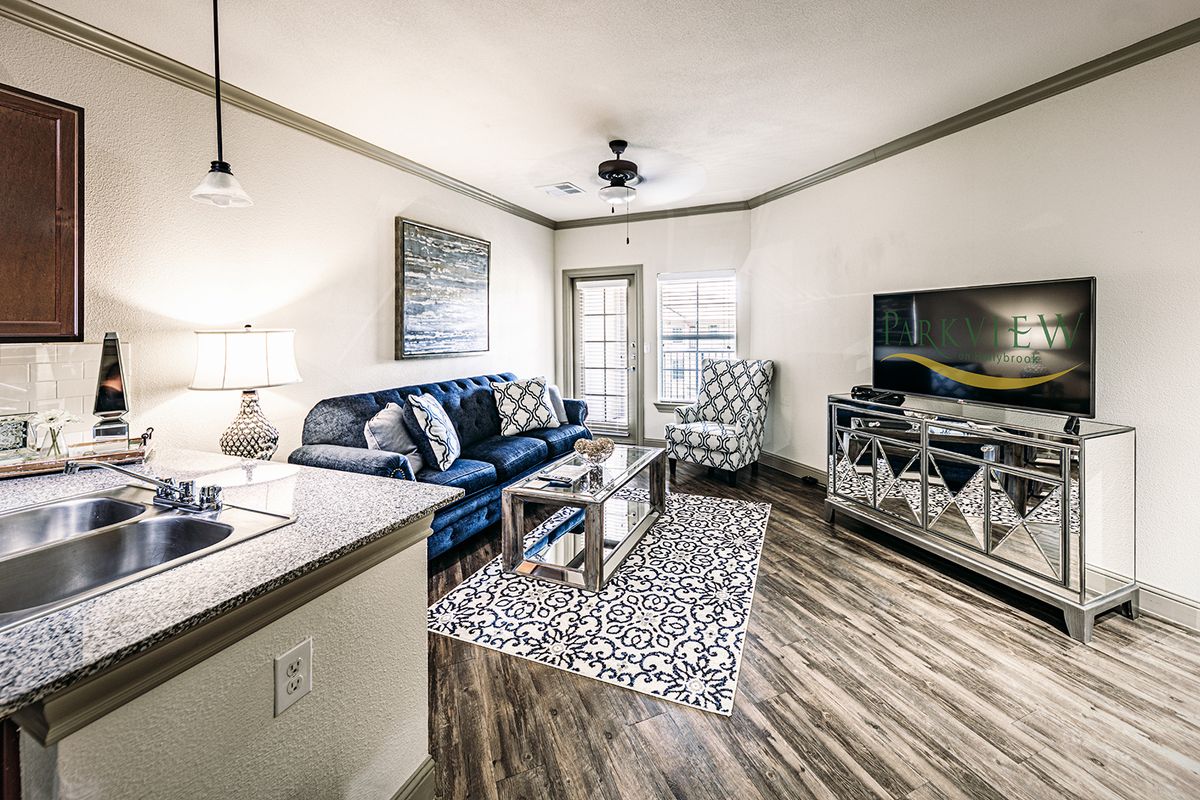 A modern living room with a comfortable sofa, a TV stand, and stylish decor.