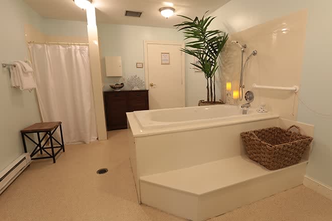 A serene and modern spa-like bathroom with a large bathtub, perfect for relaxation.