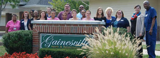 A group of individuals gathered outside a rehabilitation center, showcasing a sense of community and care.