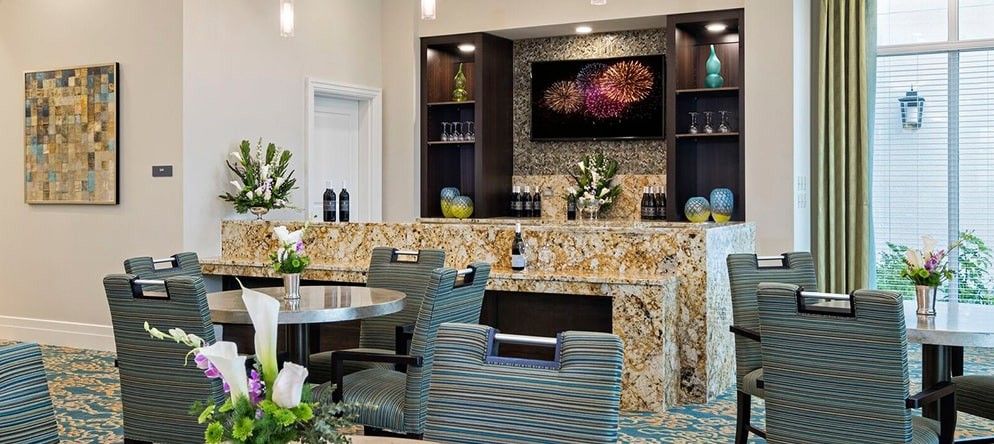 A modern reception area featuring a granite countertop, stylish furniture, and elegant decor.