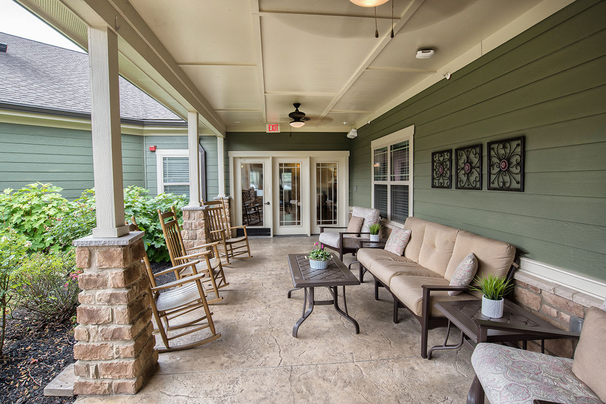Cozy porch with seating area and decor elements.