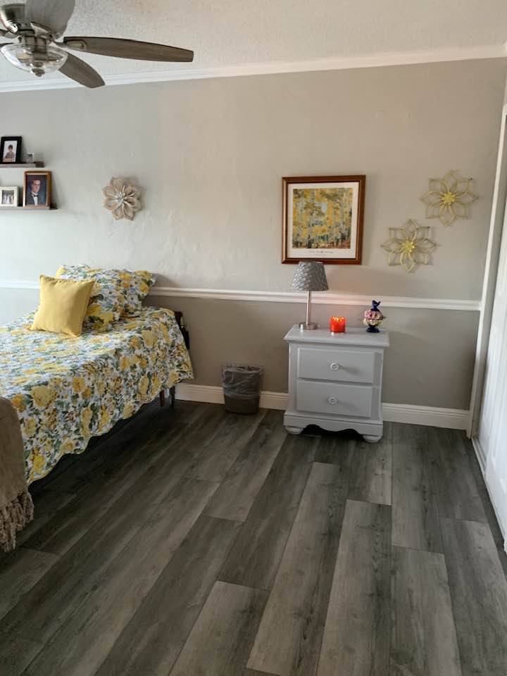 A cozy bedroom with a floral-themed bedspread and matching decor.