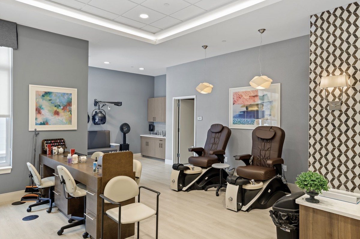 A modern nail salon featuring comfortable spa chairs and elegant interior design.