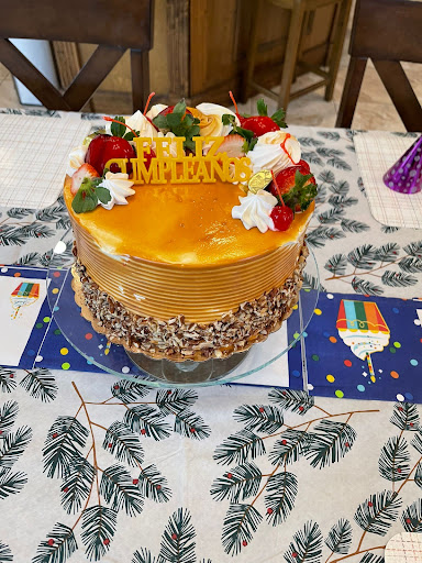 A beautifully decorated birthday cake featuring strawberries and cream, ready for a celebration.