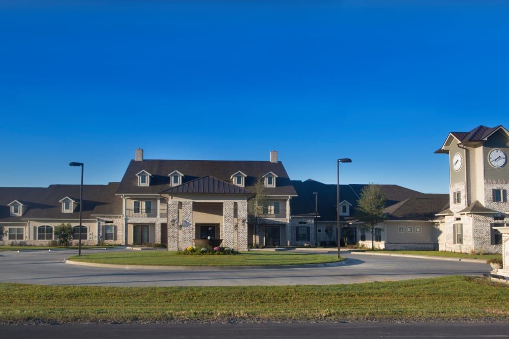 A large suburban house with a modern architectural design under a clear blue sky.