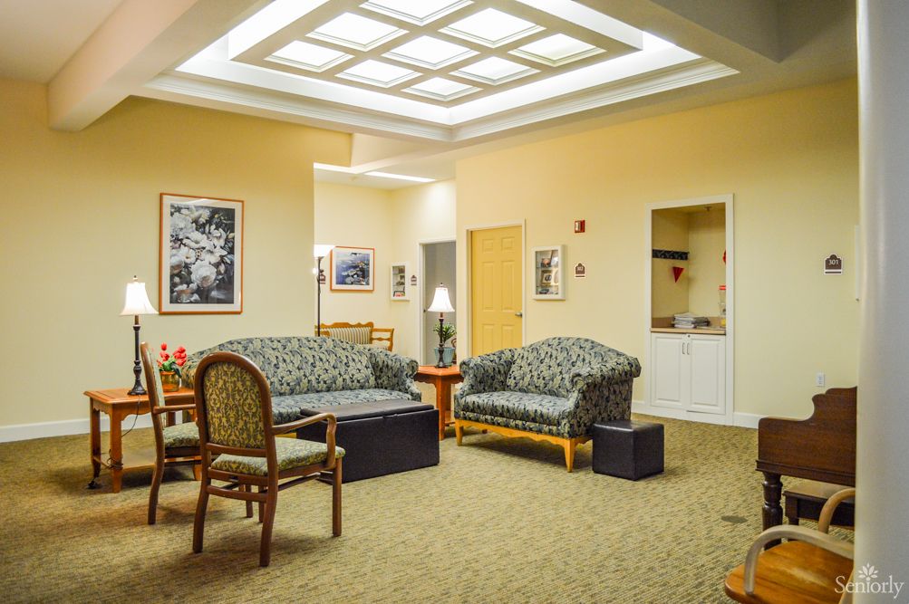 A cozy living room with comfortable seating and warm lighting.