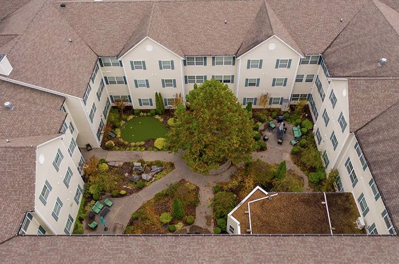 Aerial view of a building with a landscaped courtyard in the center.