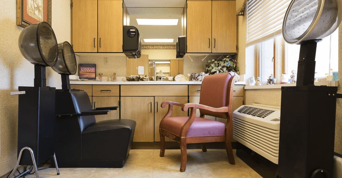 A cozy waiting room with chairs and wooden cabinetry.