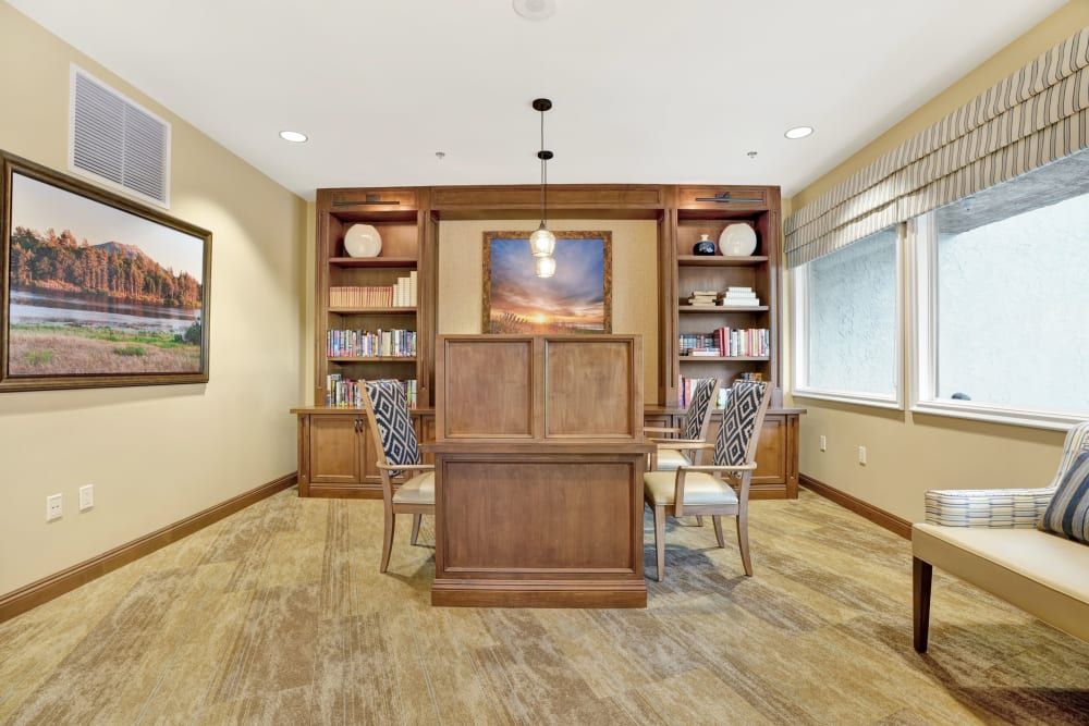 A neatly organized office space with wooden furniture and ample natural lighting.