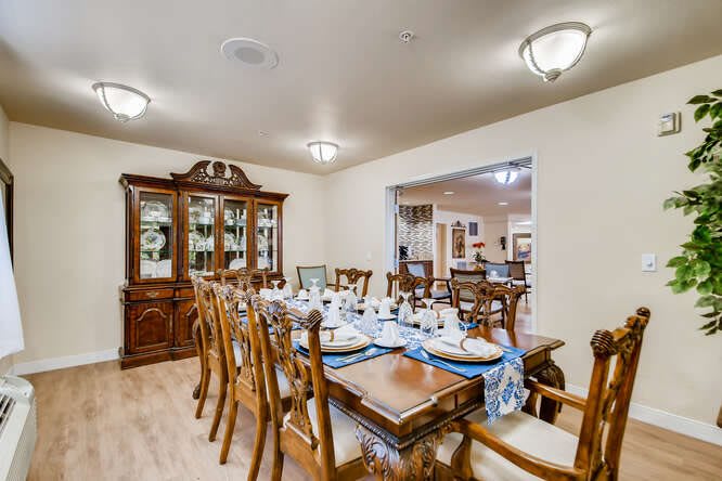 A well-set dining room table with elegant furniture and ambient lighting.