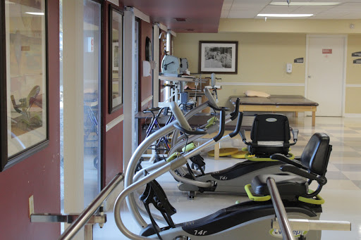 A view of exercise equipment in a rehabilitation gym, designed for physical therapy and fitness.