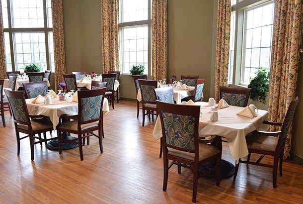 Elegant dining room with neatly arranged tables and chairs.