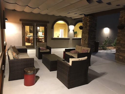 A cozy outdoor lounge area with modern seating arrangements, perfect for relaxation.
