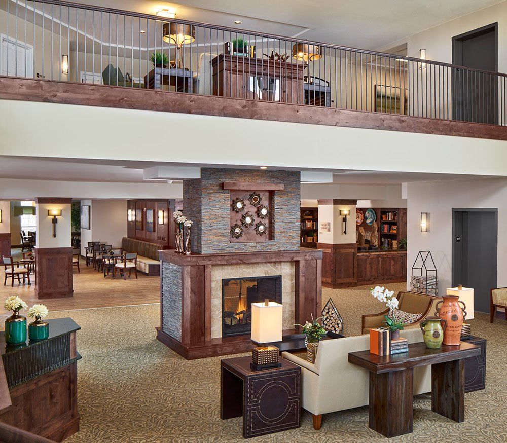A modern living room interior with comfortable seating and a central fireplace.